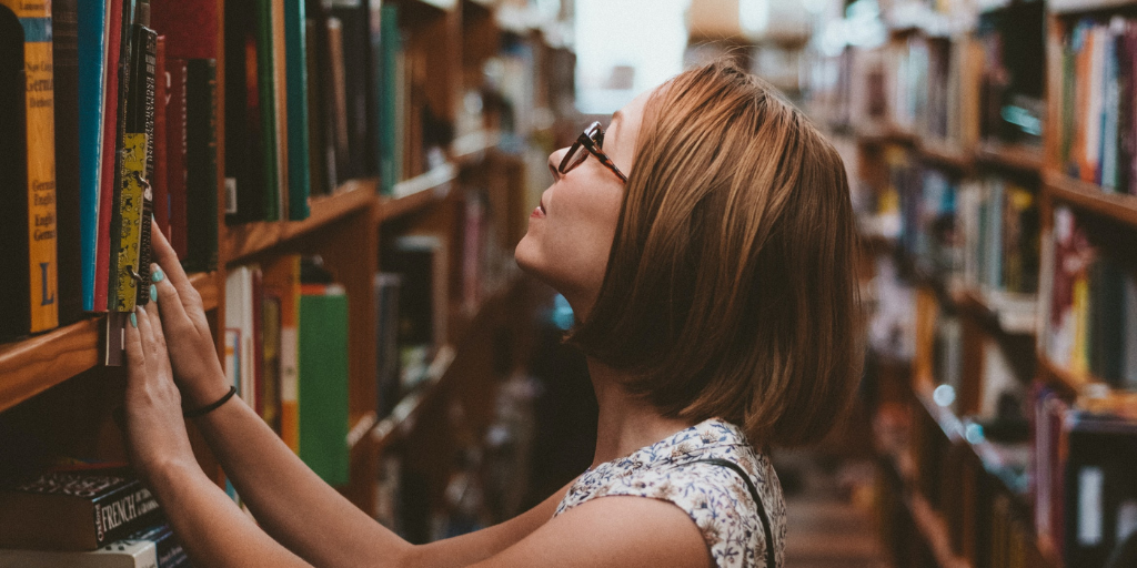 woman in a library looking at books
