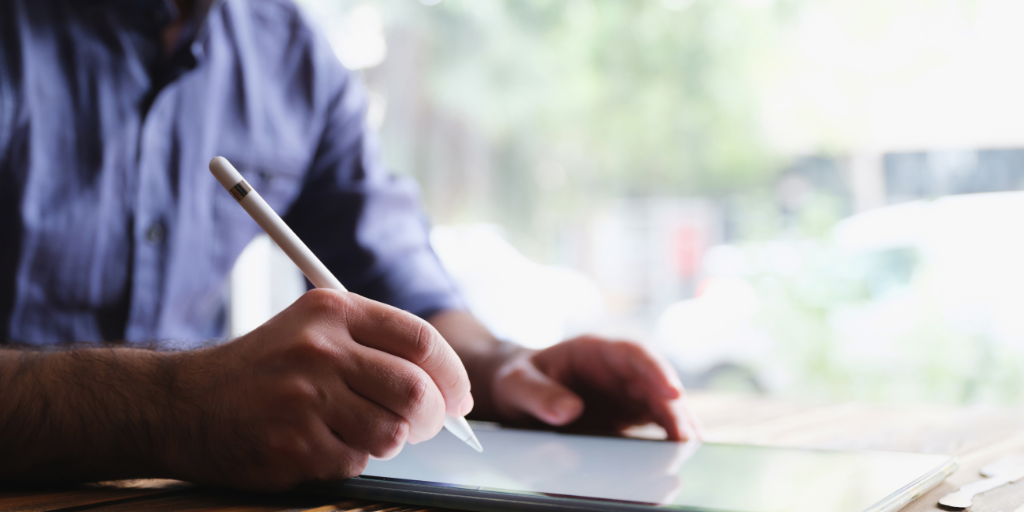 man making electronic notes on a tablet